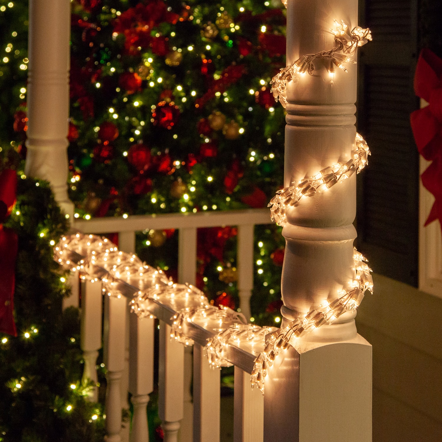 Clear Christmas Garland Lights Wrapped Around a Porch Railing