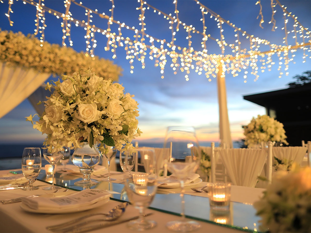 Icicle Lights Hanging Above an Outdoor Wedding Reception