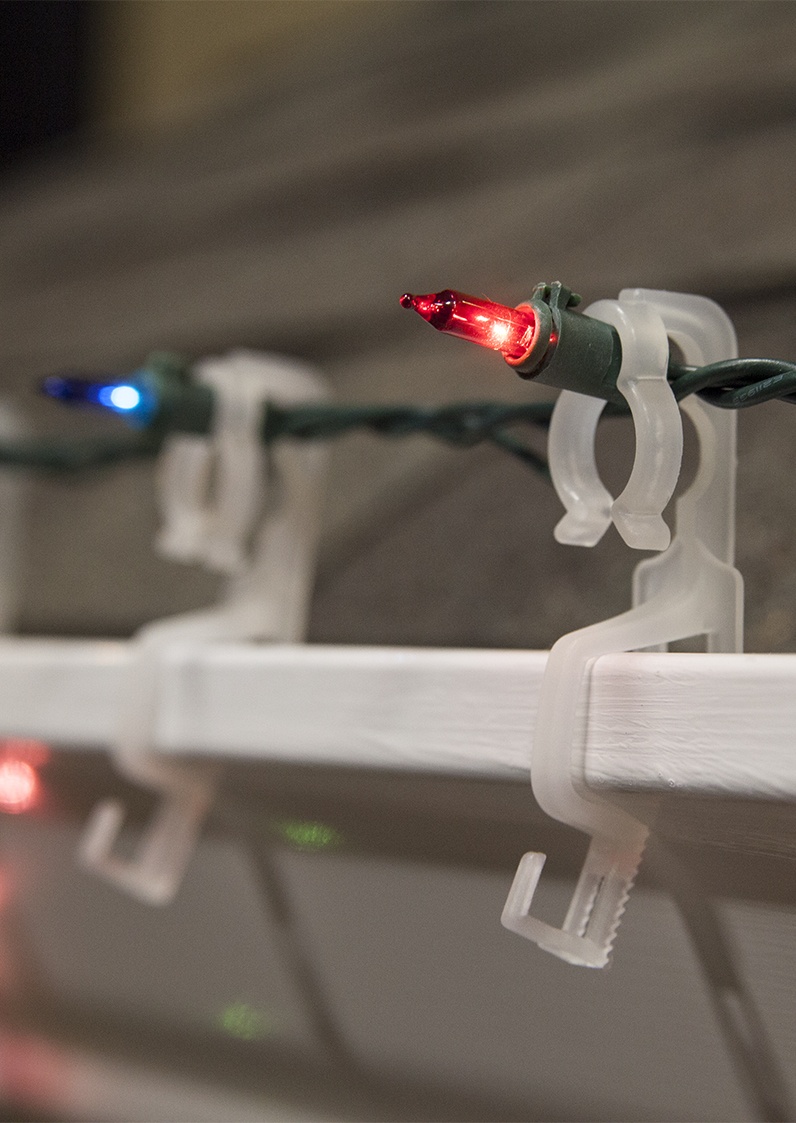 mini lights hanging on gutters with omni all in one light clips