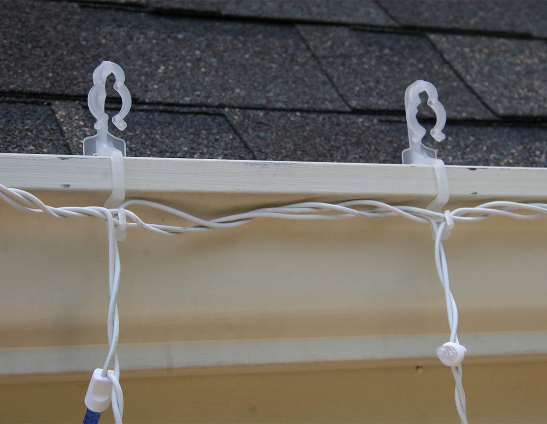 icicle lights hanging from gutters with the OMNI all in one light clip.